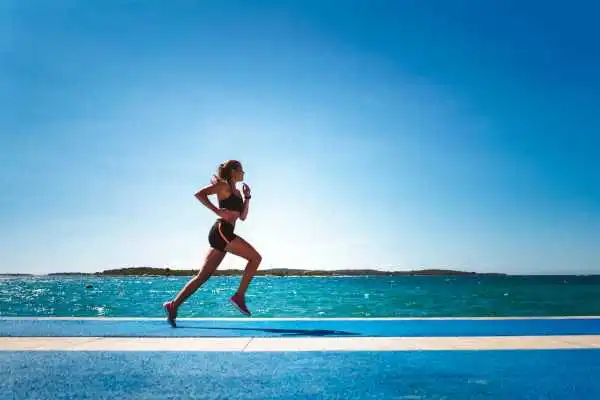 Woman running showing strong leg muscle Burnley